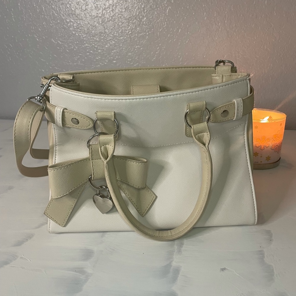 Cute! Claire’s white and light brown small purse w/ bow charm on the front
